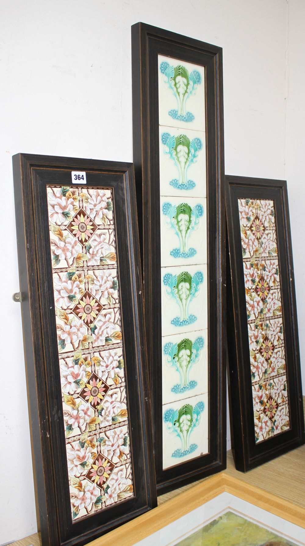 A pair of Victorian apple blossom tile panels and a set of six Art Nouveau foliate design tiles, all framed